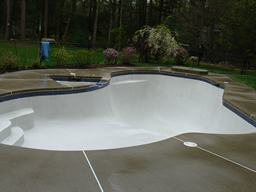 An in gound guinite pool and surrounding concrete pool apron after cleaning.
