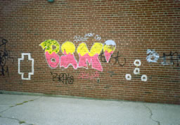 Grafitti - tagged wall - before power washing.